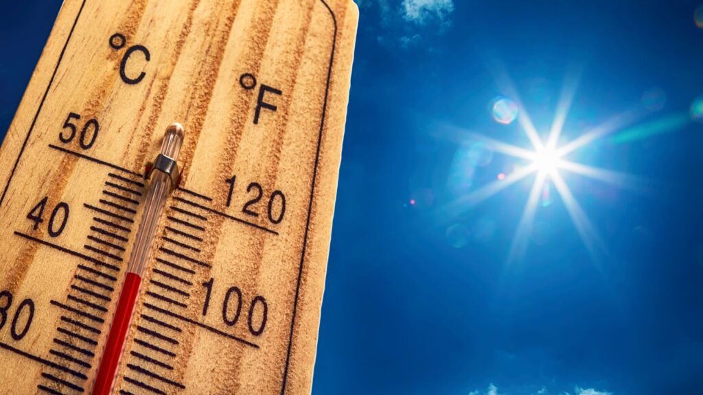 Houston summer home maintenance — thermometer at 100 degrees in summer sun