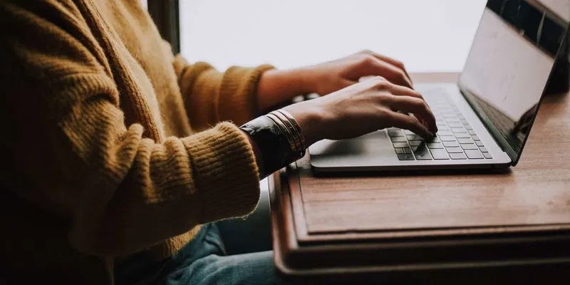 Houston homeowner using online property and utility resources on a laptop